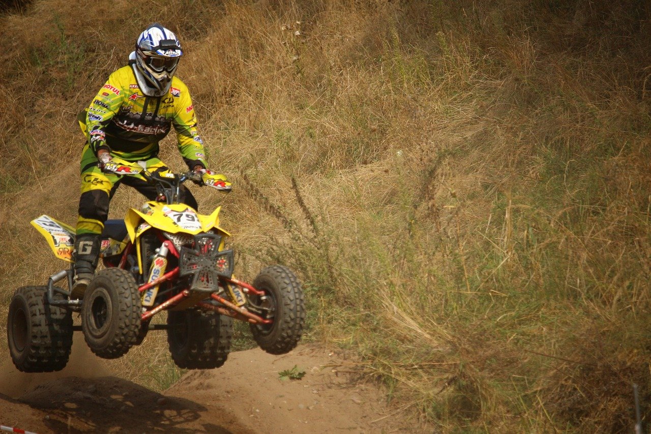 An image showcasing a Connecticut landscape with a rugged ATV trail snaking through lush forests