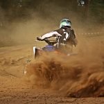 An image showcasing a serene Delaware landscape, with a rider on an ATV exploring a designated trail