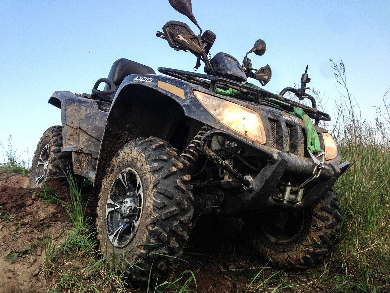 An image featuring a rugged ATV rider cruising through New Mexico's vast desert landscape
