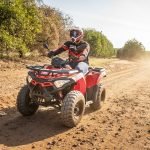 An image showcasing a UTV (Side by Side) and an ATV MAN side by side, highlighting the stark contrast in size
